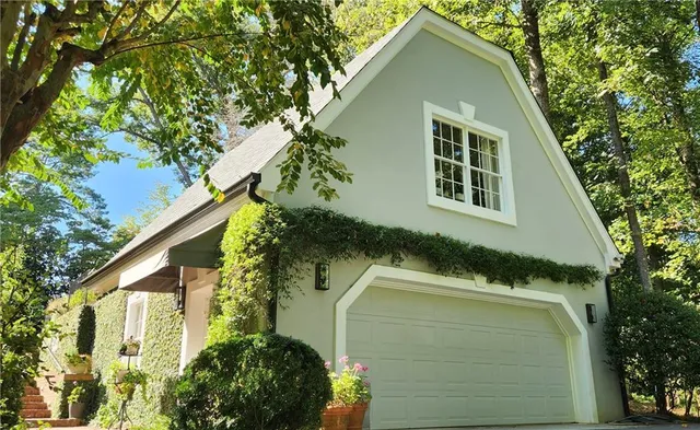 a kitchen with stainless steel appliances granite countertop a stove top oven a refrigerator a dining table and chairs with wooden floor