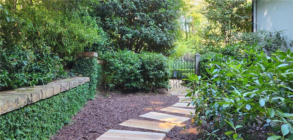 4224 East Conway Drive Northwest Atlanta, GA 30327 - Photo 23 of 72 a view of a garden with plants and wooden fence