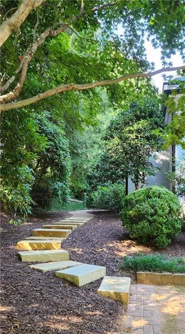 a large white kitchen with sink and wooden floor