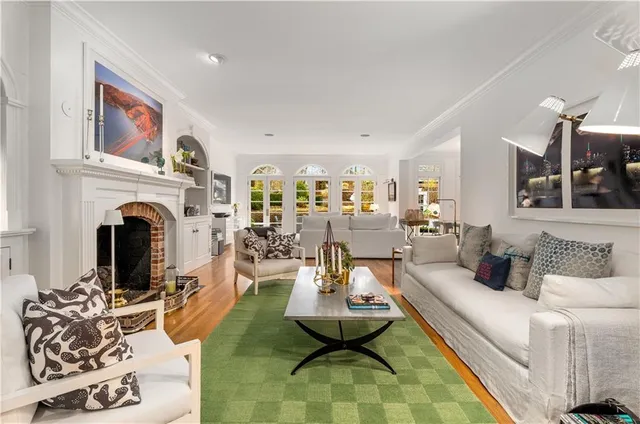 a bed sitting in a spacious bedroom next to a window