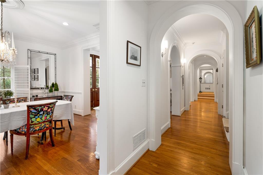 4224 East Conway Drive Northwest Atlanta, GA 30327 - Photo 38 of 72 a view of a hallway with couches and dining table with wooden floor