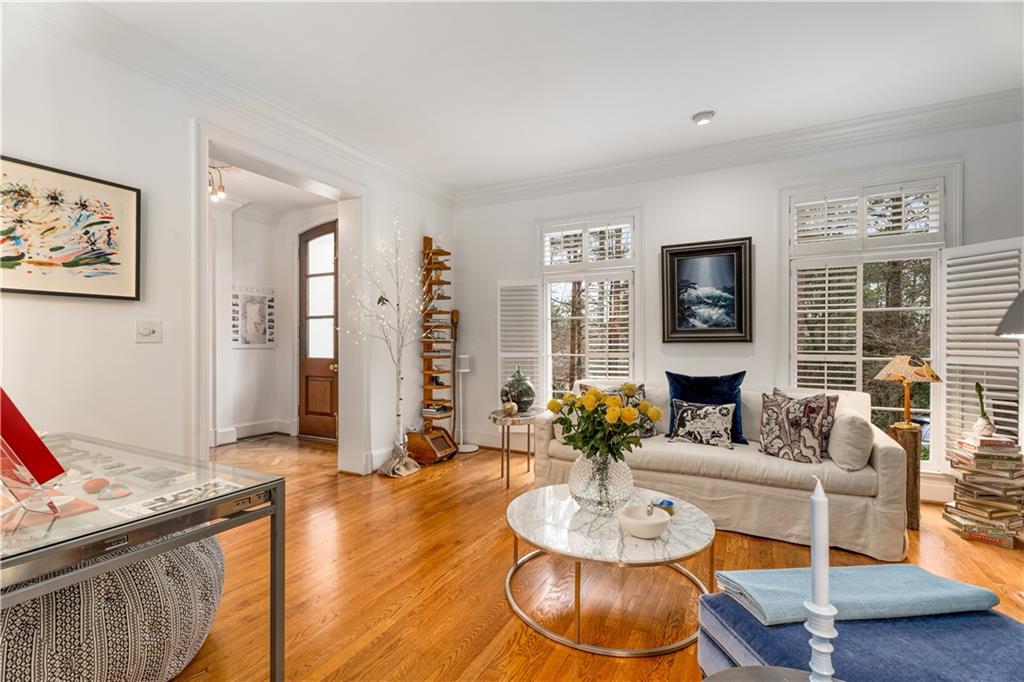 4224 East Conway Drive Northwest Atlanta, GA 30327 - Photo 43 of 72 a living room with furniture and a dining table with wooden floor