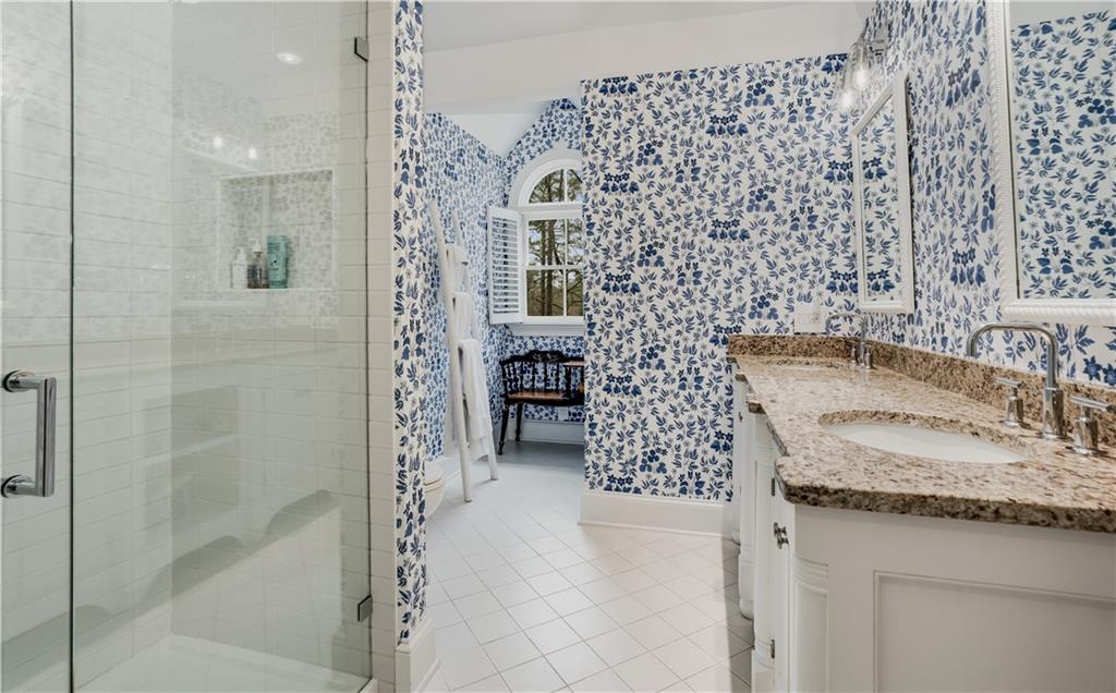 4224 East Conway Drive Northwest Atlanta, GA 30327 - Photo 57 of 72 a bathroom with a granite countertop shower a mirror and a sink