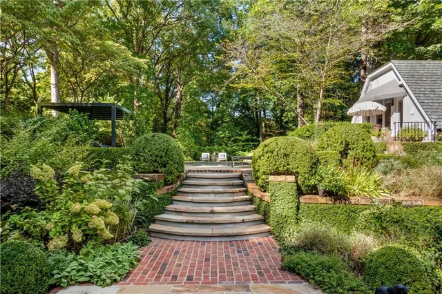 a small pool with couple of relaxing chair