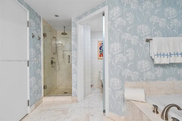 a balcony with furniture and a potted plant