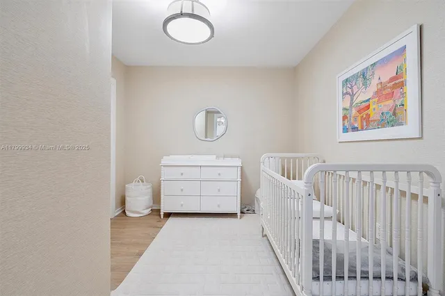 a bathroom with a granite countertop sink and a toilet