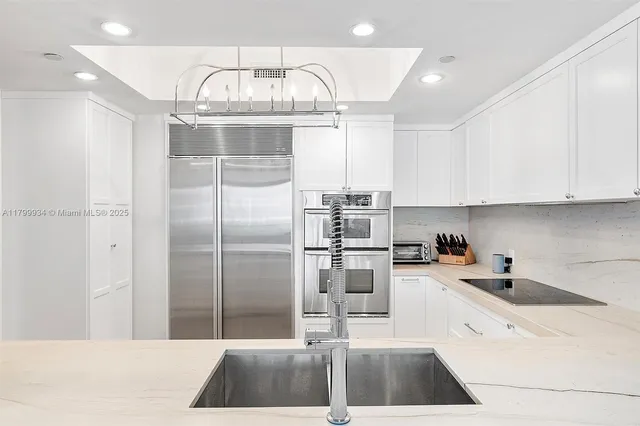 a kitchen with cabinets stainless steel appliances and a sink