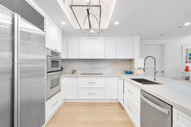 a kitchen with white cabinets a sink a stove and white cabinets