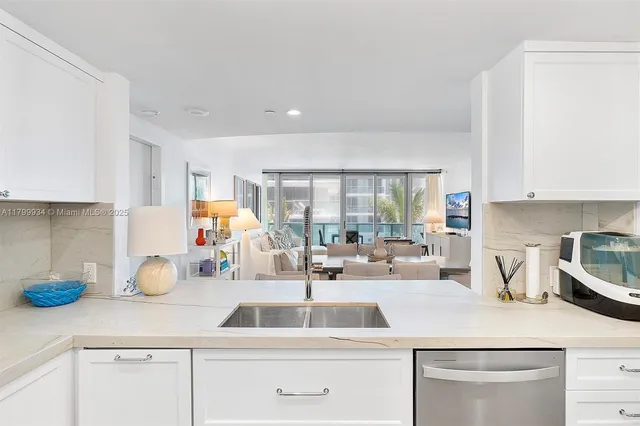 a bedroom with a bed dresser and a flat tv screen