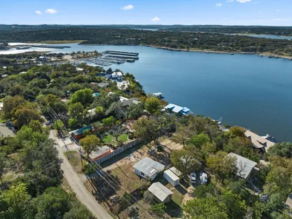 an aerial view of ocean with residential houses with outdoor space and seating