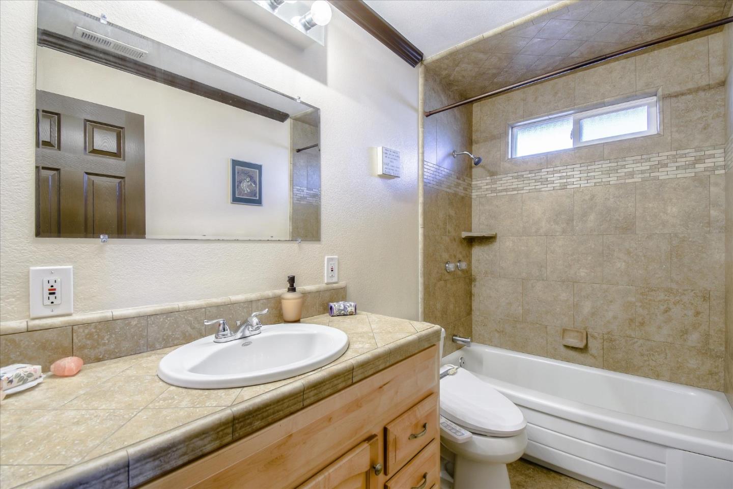2055 Hogan Drive Santa Clara, CA 95054 - Photo 17 of 37 a bathroom with a granite countertop sink a toilet a mirror a bathtub and shower