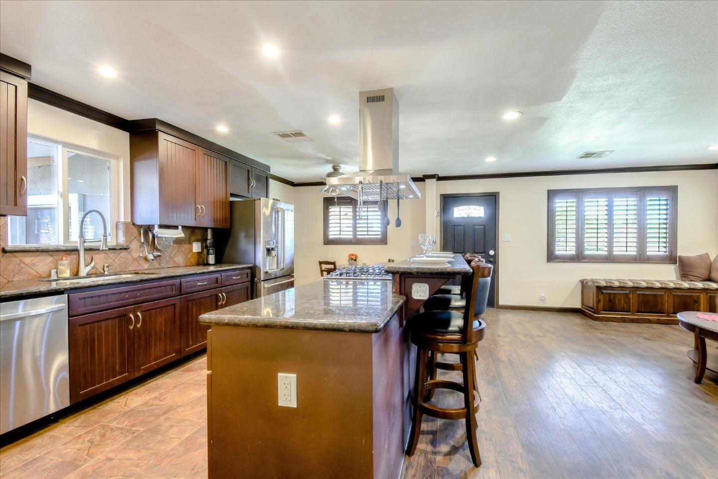 2055 Hogan Drive Santa Clara, CA 95054 - Photo 2 of 37 a large kitchen with kitchen island a large island in the center windows and furniture