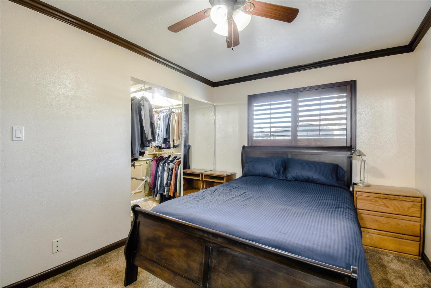 2055 Hogan Drive Santa Clara, CA 95054 - Photo 21 of 37 a bedroom with a bed and a chandelier