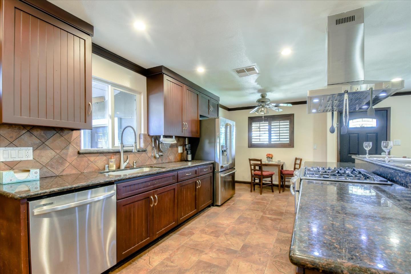 2055 Hogan Drive Santa Clara, CA 95054 - Photo 3 of 37 a kitchen with kitchen island granite countertop a sink cabinets and window