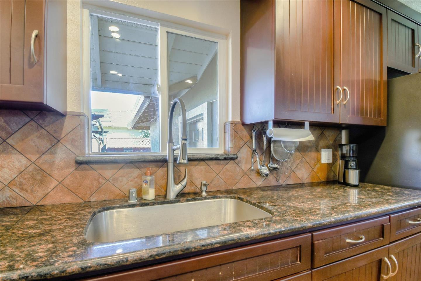 2055 Hogan Drive Santa Clara, CA 95054 - Photo 7 of 37 a kitchen with granite countertop a sink and a window