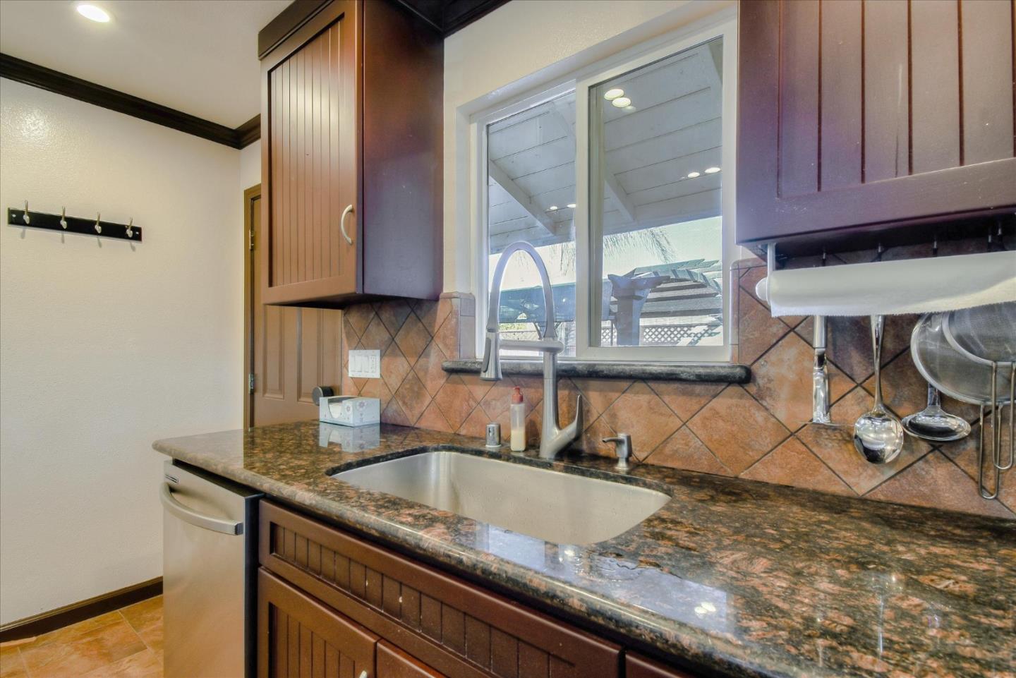 2055 Hogan Drive Santa Clara, CA 95054 - Photo 8 of 37 a kitchen with granite countertop a sink a stove and cabinets