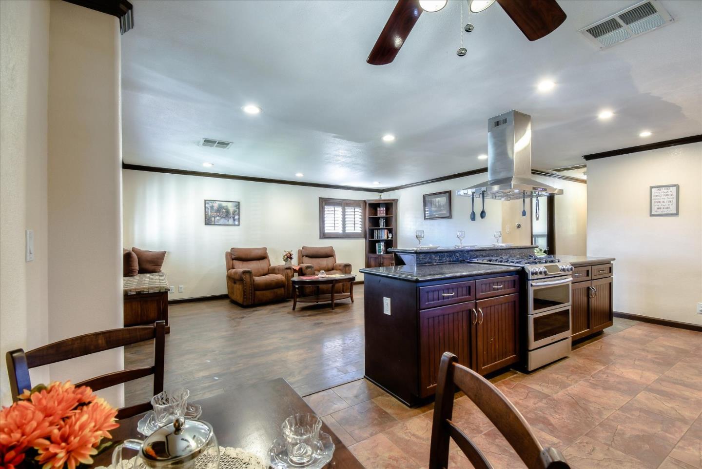 2055 Hogan Drive Santa Clara, CA 95054 - Photo 10 of 37 a kitchen with stainless steel appliances kitchen island granite countertop a stove and a refrigerator