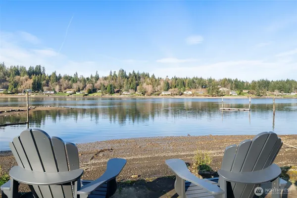 a view of a lake with table and chairs