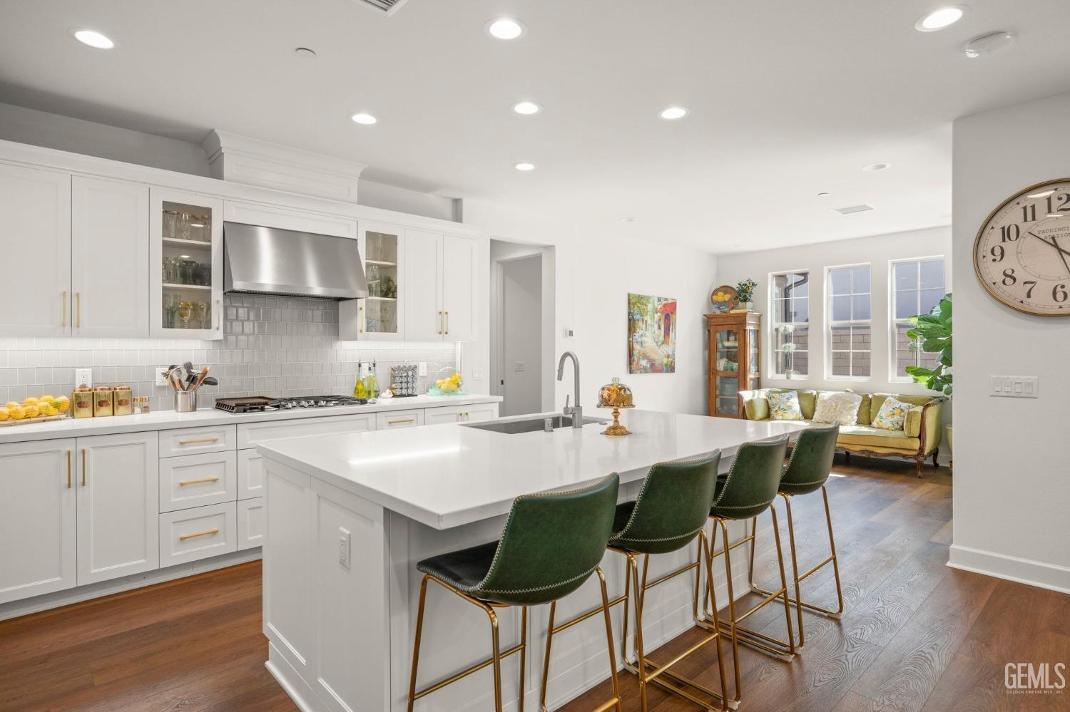 Undisclosed Address Camarillo, CA 93012 - Photo 11 of 54 a kitchen with stainless steel appliances kitchen island granite countertop a stove a sink a dining table and chairs