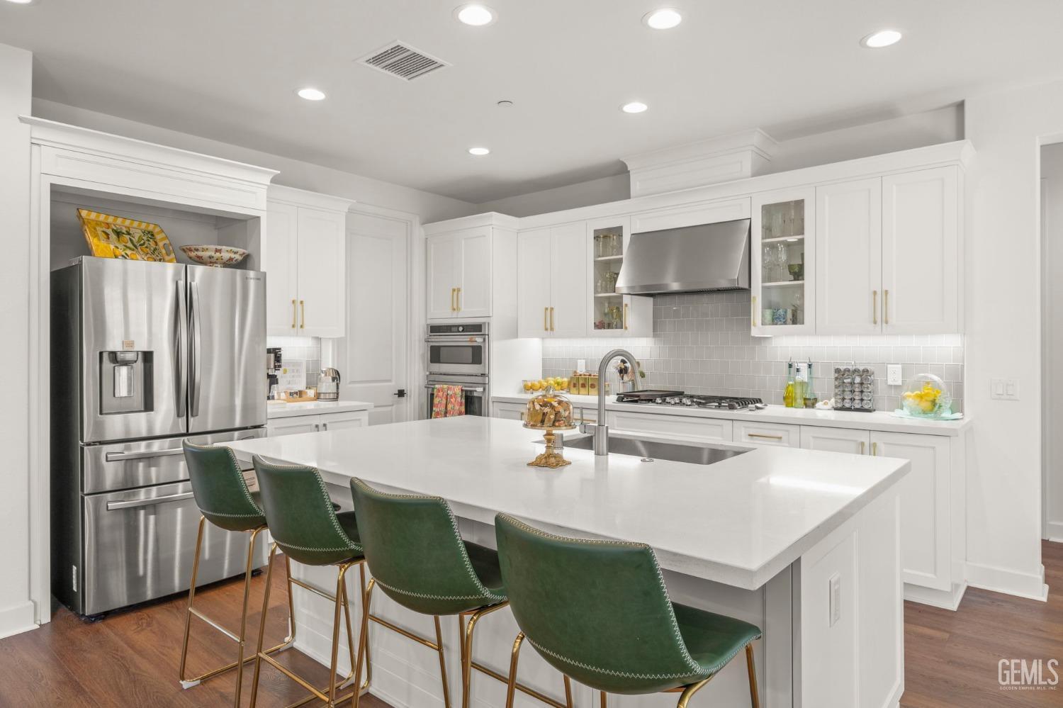 Undisclosed Address Camarillo, CA 93012 - Photo 12 of 54 a kitchen with kitchen island a stove a table and chairs