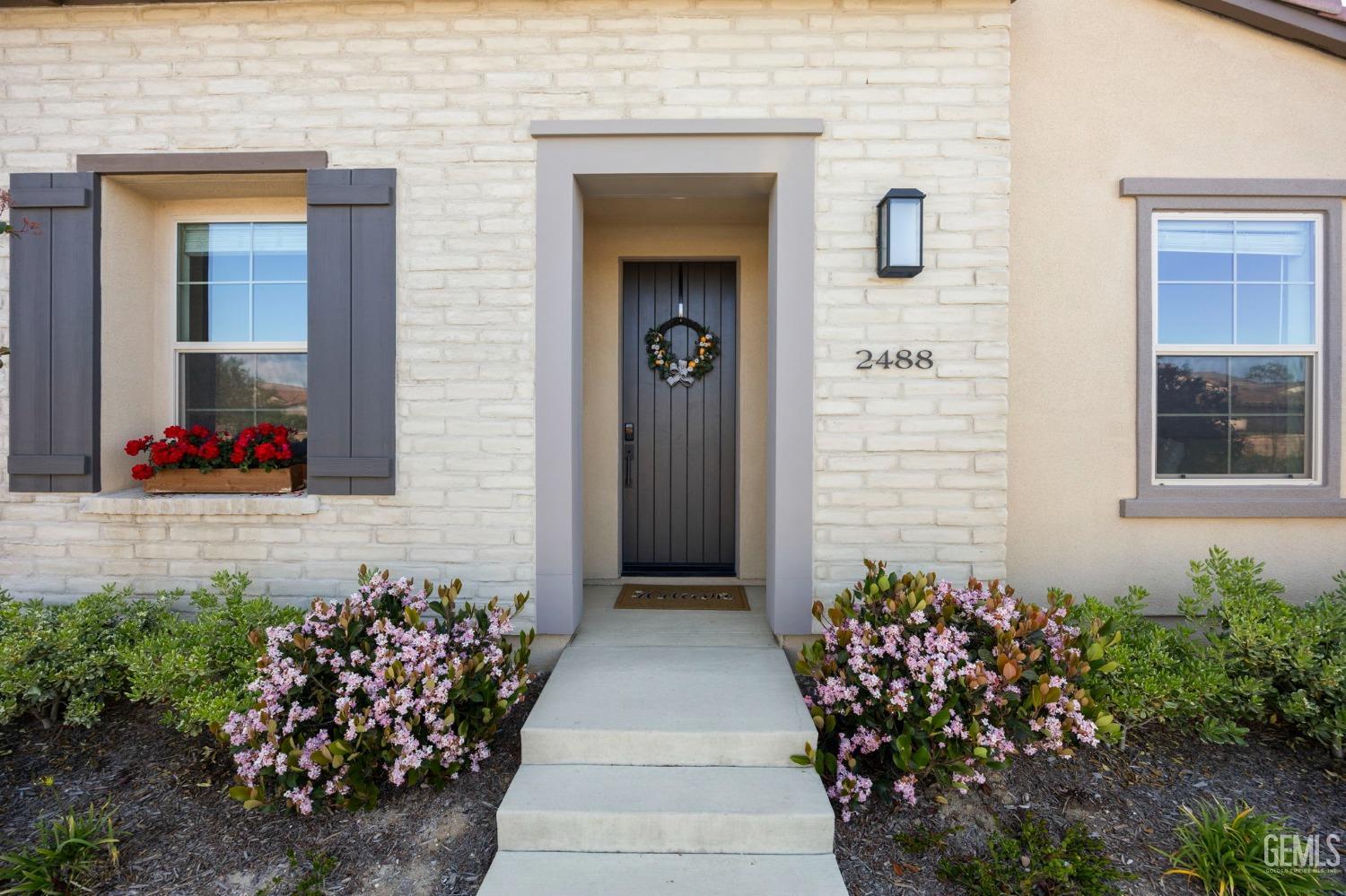 Undisclosed Address Camarillo, CA 93012 - Photo 4 of 54 a front view of a house with flowers