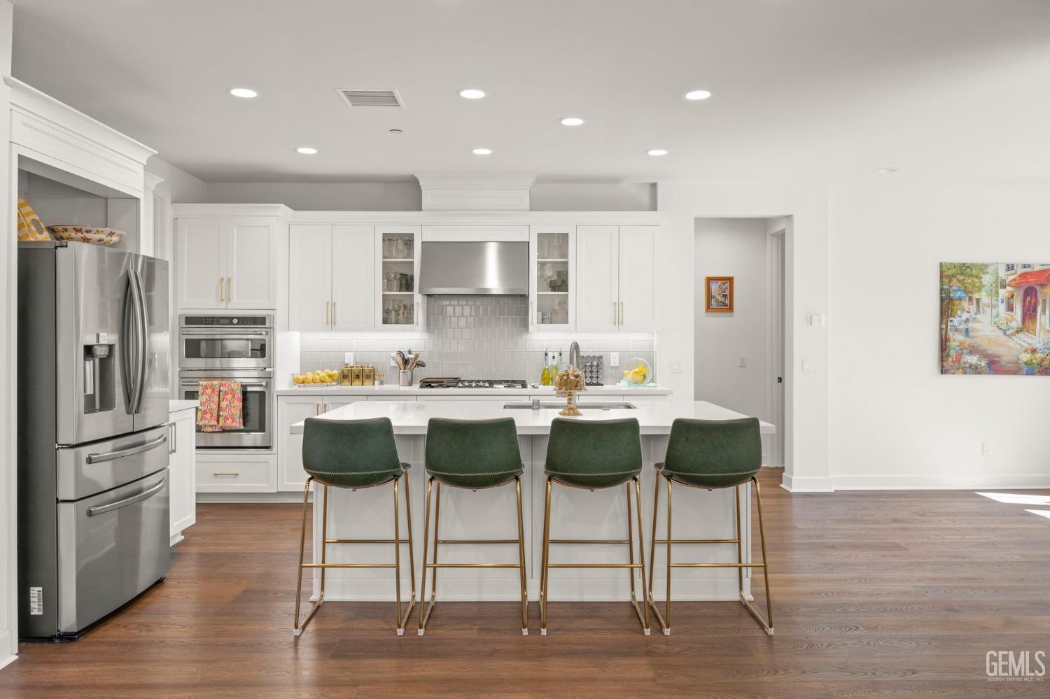 Undisclosed Address Camarillo, CA 93012 - Photo 9 of 54 a kitchen with a dining table chairs refrigerator and cabinets