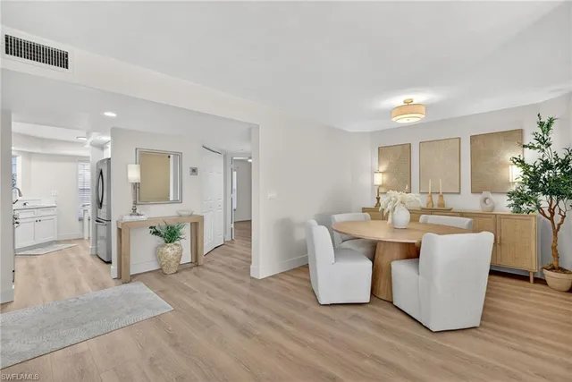 a large living room with stainless steel appliances kitchen island granite countertop a couch and a view of kitchen