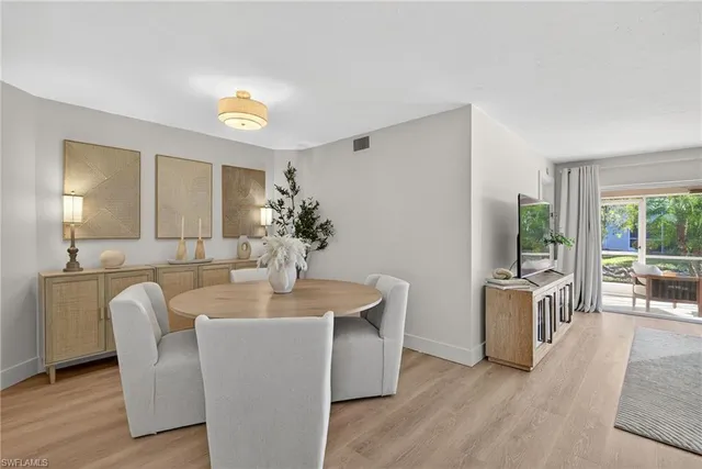 a dining room with furniture and wooden floor