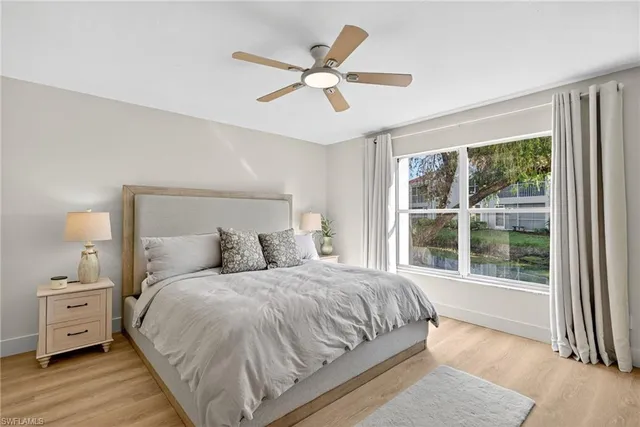 a bedroom with a large bed and a large window