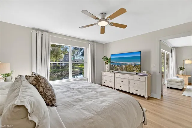 a spacious bedroom with a large bed and a window