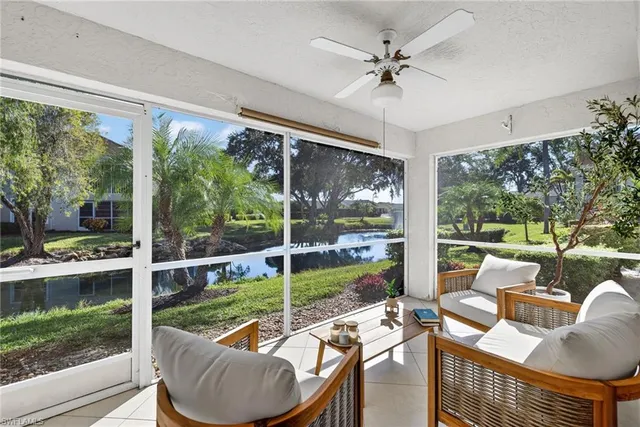 a living room with large windows a rug and a floor to ceiling window