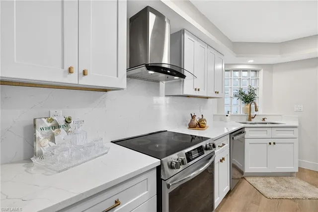 a kitchen with a stove and white cabinets