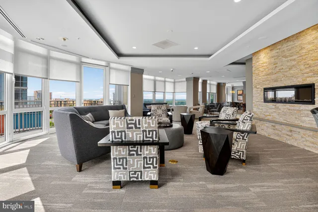 a living room with lots of furniture and kitchen view