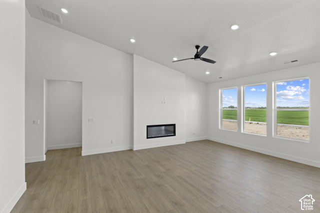 205 East 690th Street North Logan, UT 84321 - Photo 34 of 52 Vaulted ceiling, wood-finish flooring, recessed lighting, linear fireplace, and ceiling fan