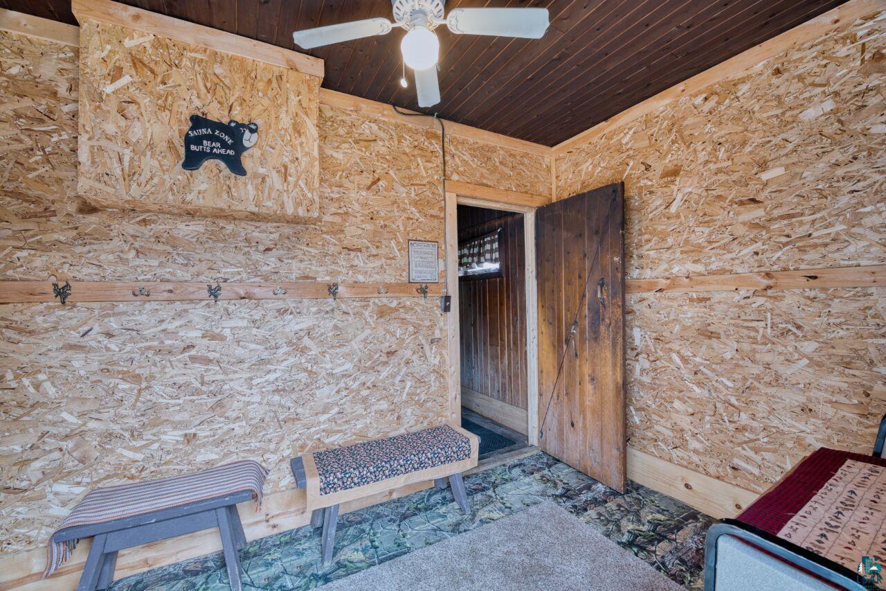 5303 Markham Road Makinen, MN 55763 - Photo 18 of 36 View of exterior entry featuring a ceiling fan and stone siding