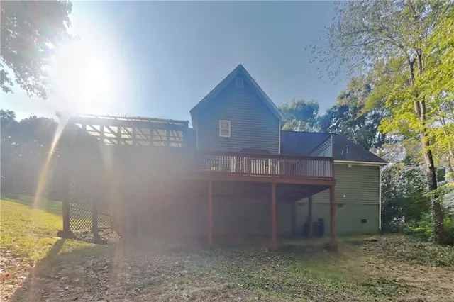 a view of a house with a yard and wooden fence