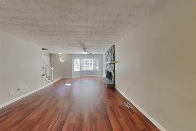 a view of a room with wooden floor and window