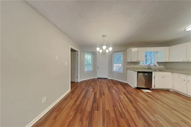 a view of kitchen with granite countertop cabinets and wooden floor
