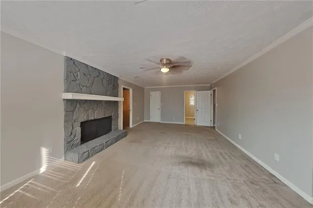 a view of empty room with a fireplace