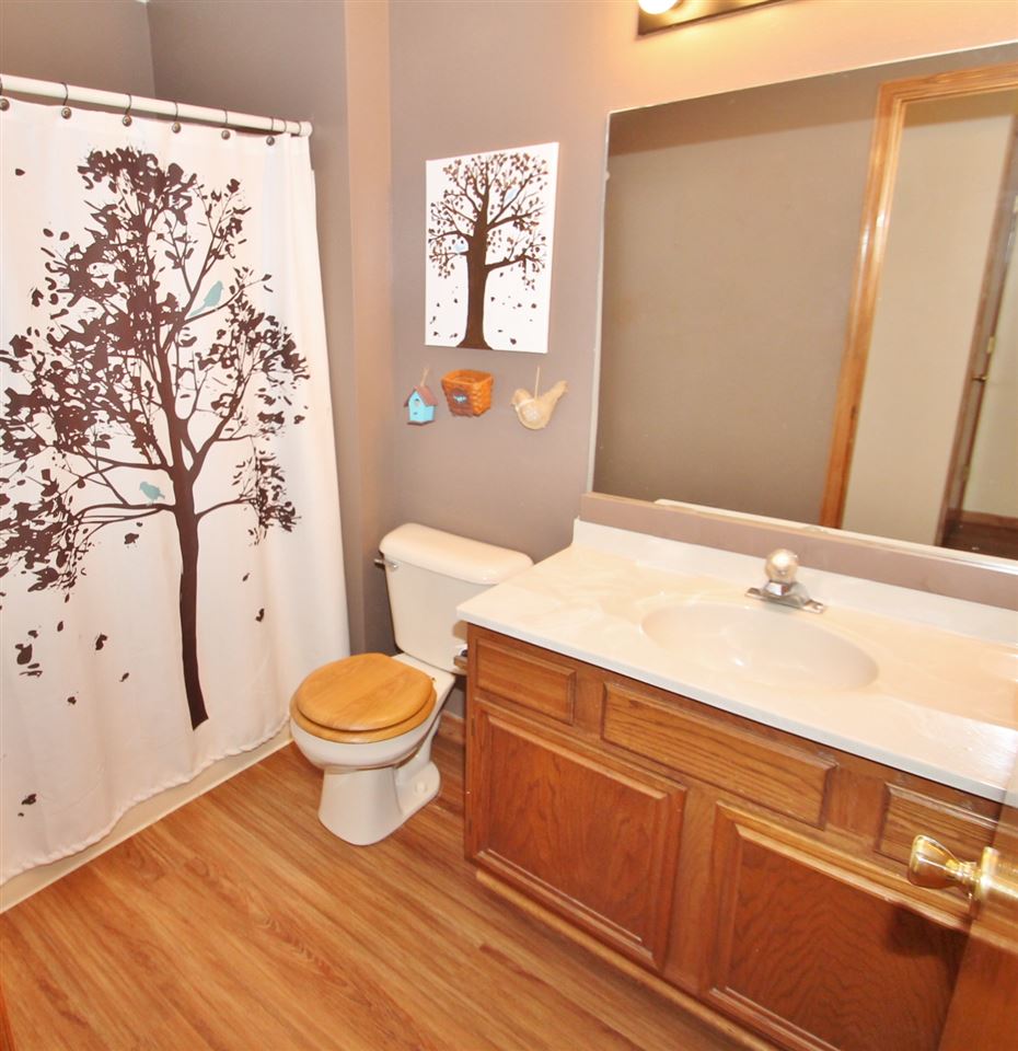 518 Pin Oak Road Rockton, IL 61072 - Photo 18 of 25 a bathroom with a toilet a sink and a large mirror