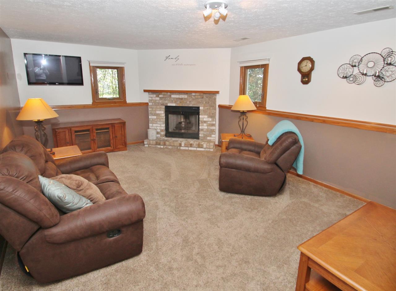 518 Pin Oak Road Rockton, IL 61072 - Photo 21 of 25 a living room with furniture and a fireplace