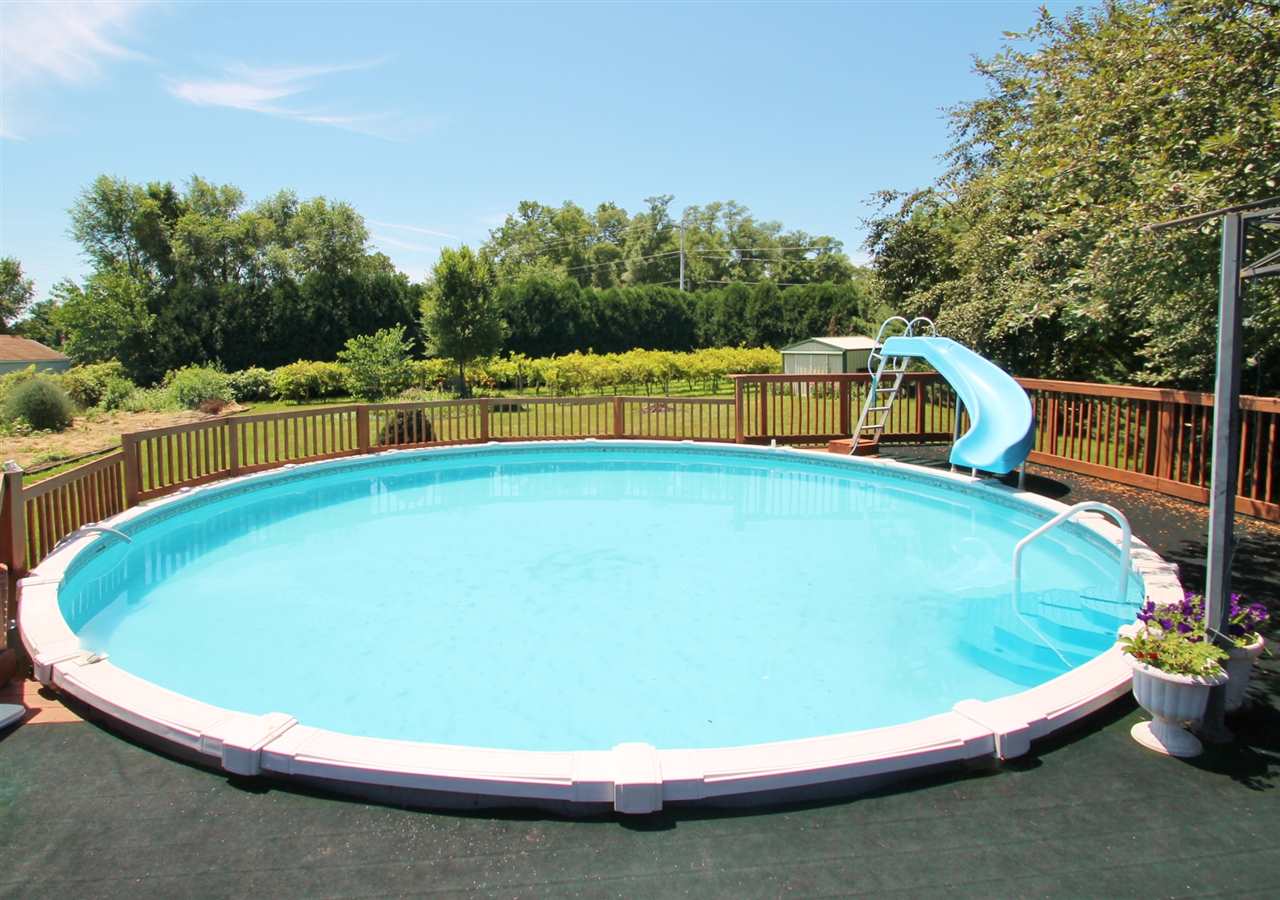 518 Pin Oak Road Rockton, IL 61072 - Photo 7 of 25 a small pool is sitting in the middle of a lake