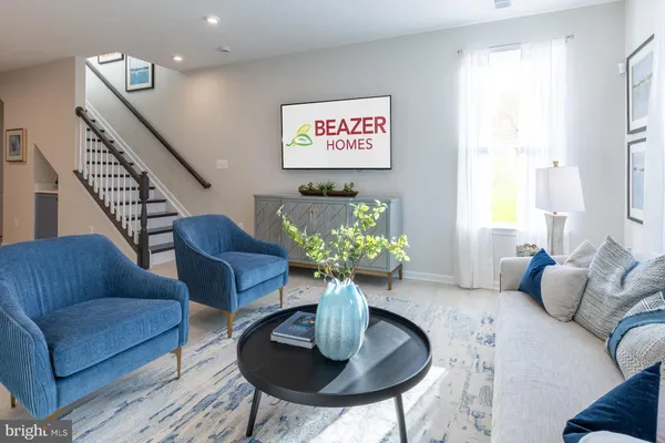 a living room with furniture potted plant and a window