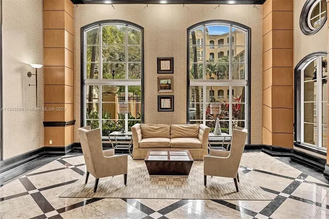 a living room with furniture fireplace and a window