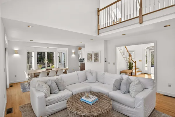 a living room with furniture a large window and a fireplace