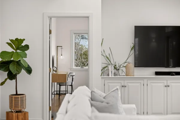 a view of a hallway with wooden floor and stairs