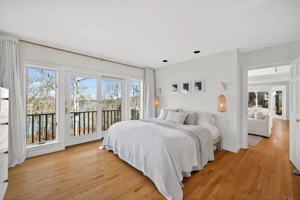 a bedroom with a large bed and a large window