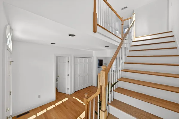a view of entryway and hall with wooden floor