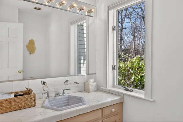 a living room with furniture a flat screen tv and a floor to ceiling window