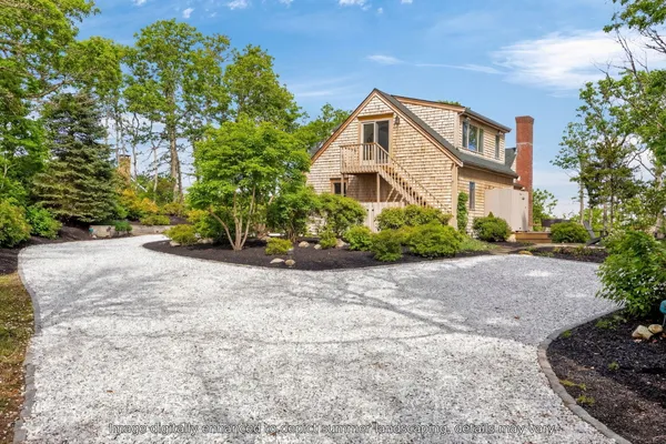 a view of a house with a yard and plant